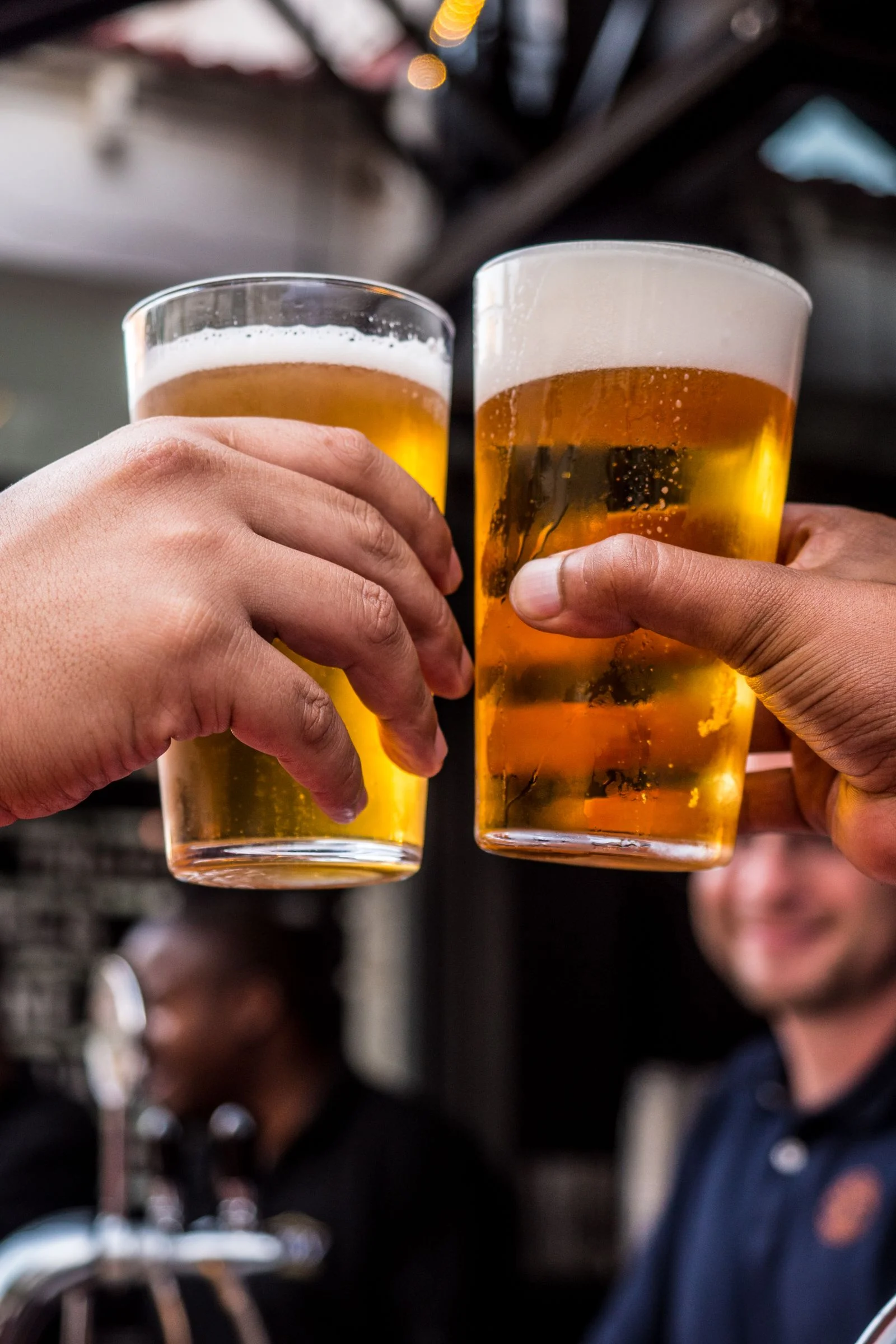 Two cold beers raised together